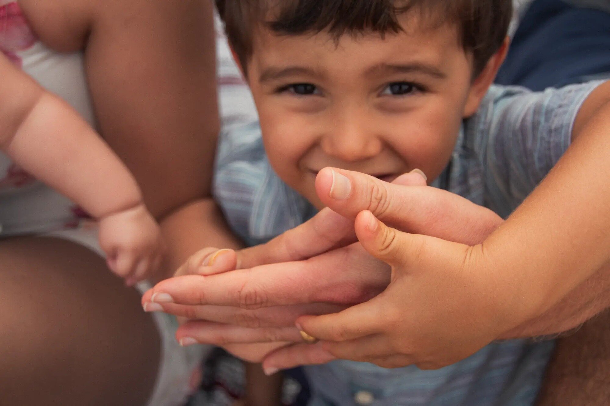 kauai-family-photographer-toddler-hands-portrait Laughing toddler boy close-up