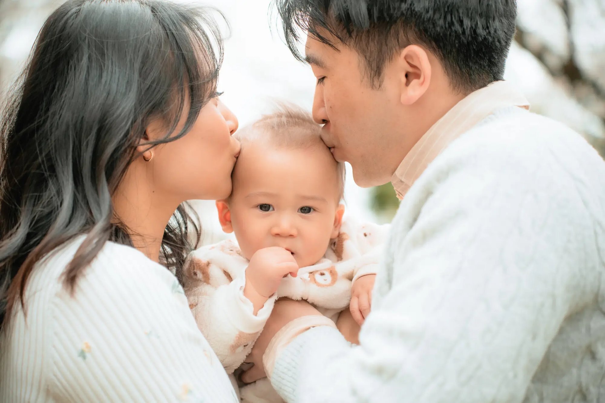 Fukuoka Photographer — Family Baby Portrait Session Parents kissing their baby on the cheeks during a professional family photo session in Fukuoka, Japan