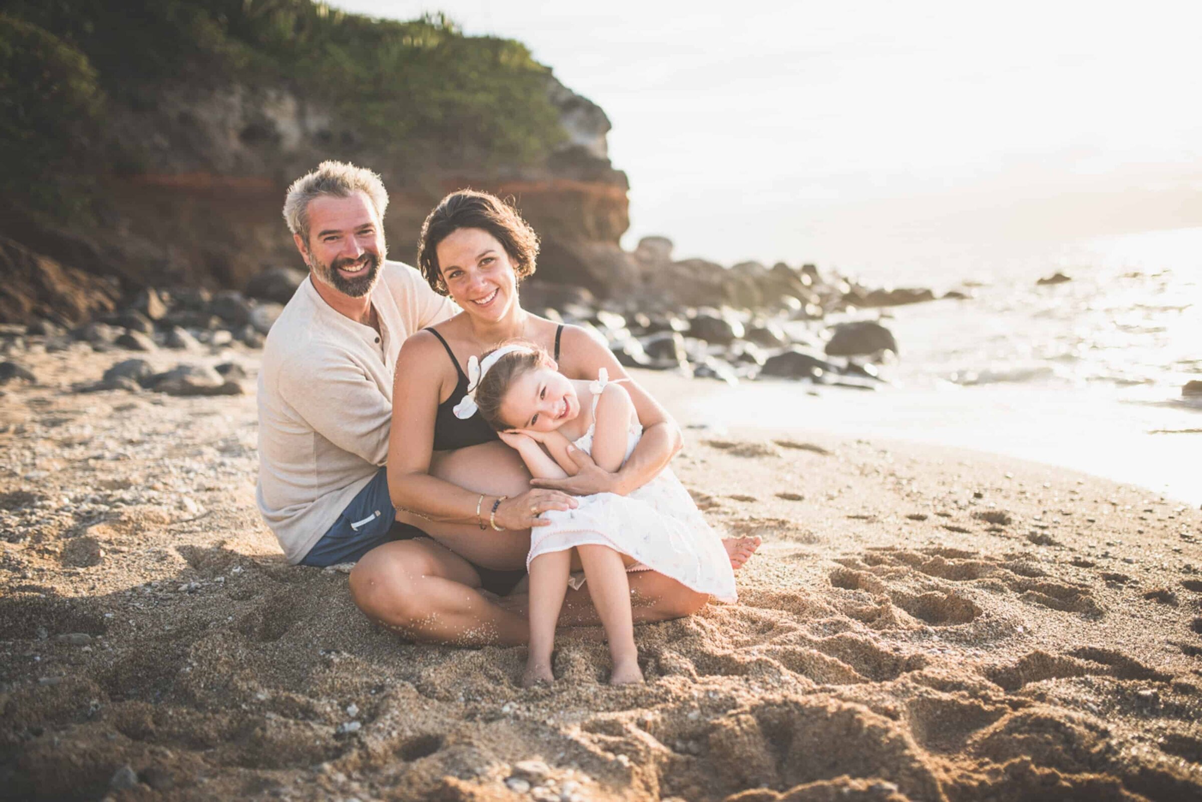 Parents and daughter on beach Parents and daughter together on a sandy beach at golden hour