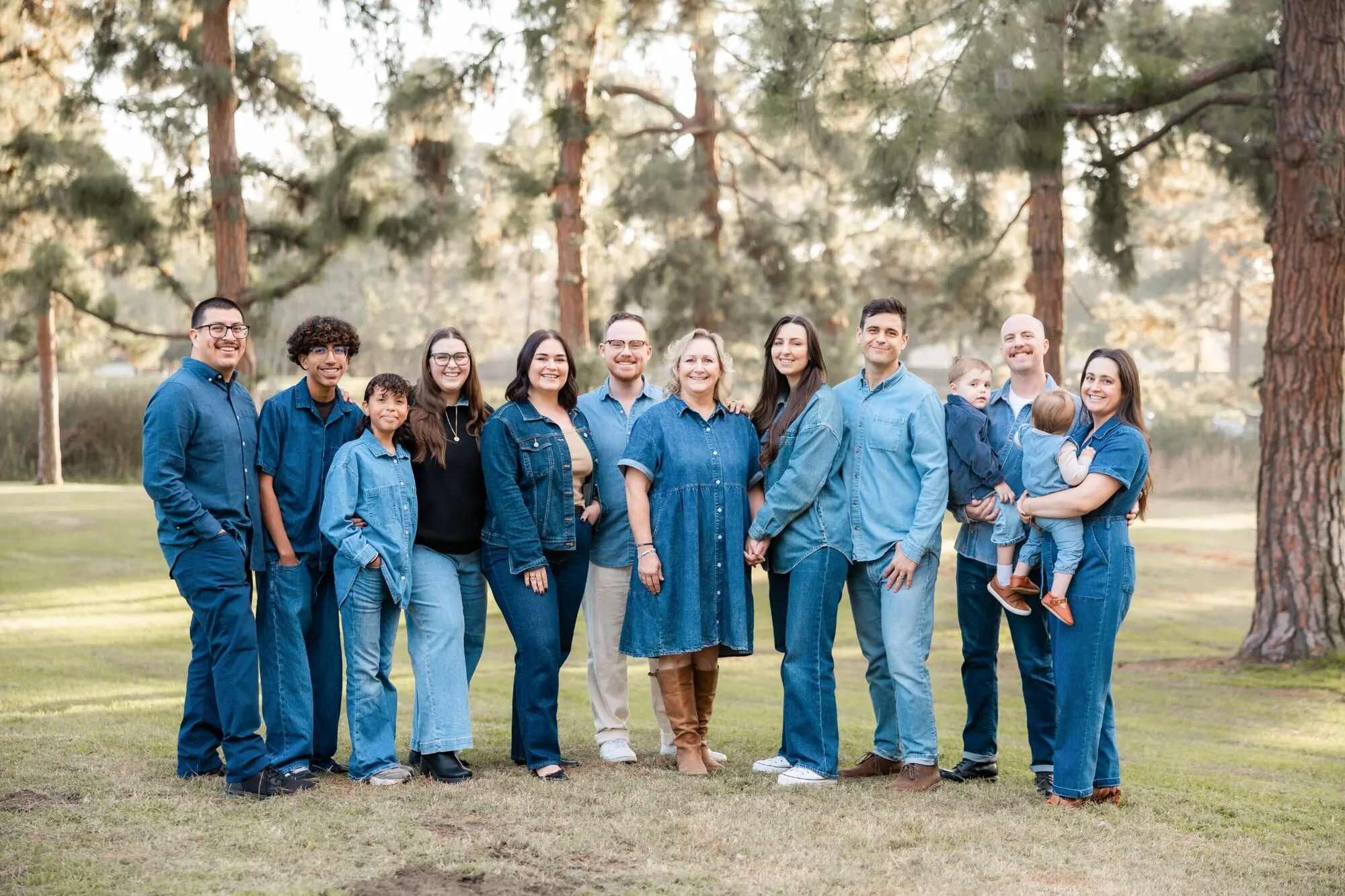 Los Angeles Family Photographer — Extended Family Session at Lake Balboa Park Los Angeles family photographer capturing a large multigenerational extended family of eleven smiling together in coordinating denim outfits under tall pine trees at Lake Balboa Park