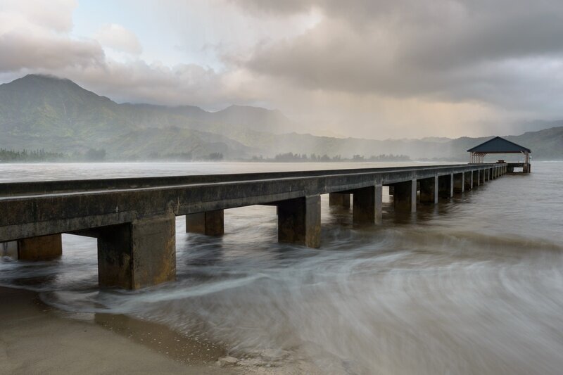 Hanalei Pier at Hanalei Bay — Kauai North Shore Hanalei Pier stretching into Hanalei Bay on Kauai's North Shore, with dramatic mountain backdrop