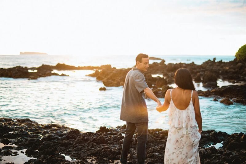 maui-beach-engagement-photos-sunset-ironwoods-mobile A couple posing on a dramatic lava rock coastline in Maui Hawaii during a romantic couple photoshoot