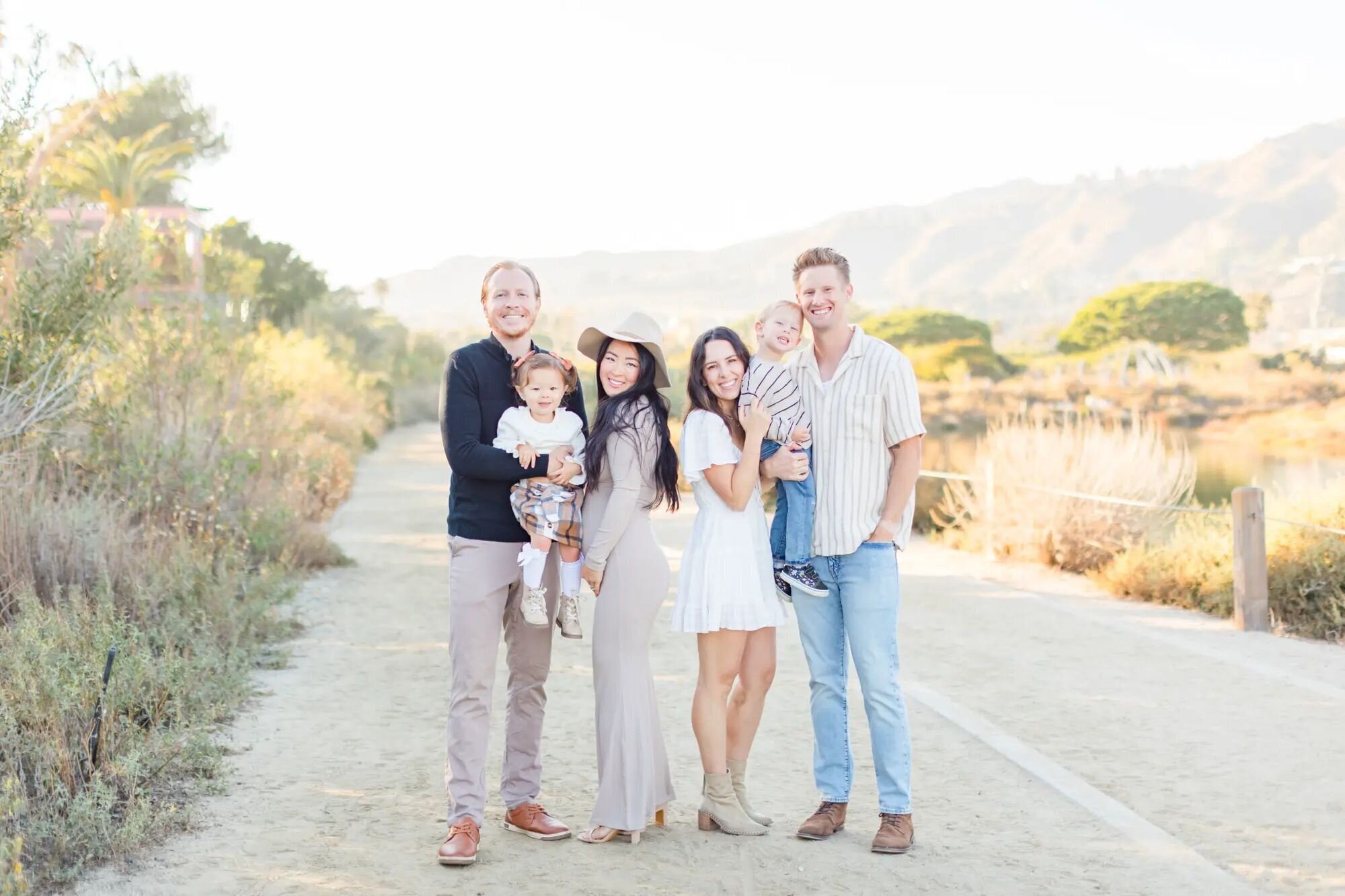 Vacation Photography Packages — Family Session by Dreamgraphy Two families with young children smiling together outdoors — Dreamgraphy vacation photography packages