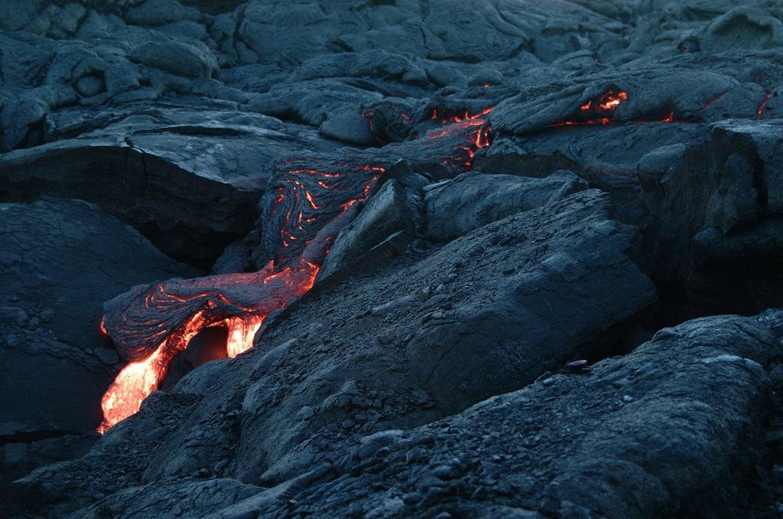Photo Session Location — Hawaii Volcanoes National Park, Big Island Glowing lava flow over dark volcanic rock at Hawaii Volcanoes National Park on the Big Island of Hawaii