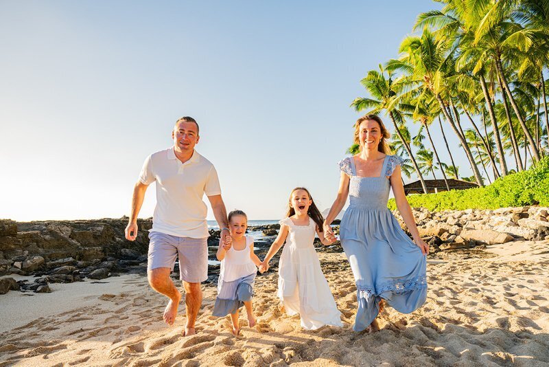 Family Photographer – Vacation Beach Session Family laughing together on a beach during a professional vacation photoshoot