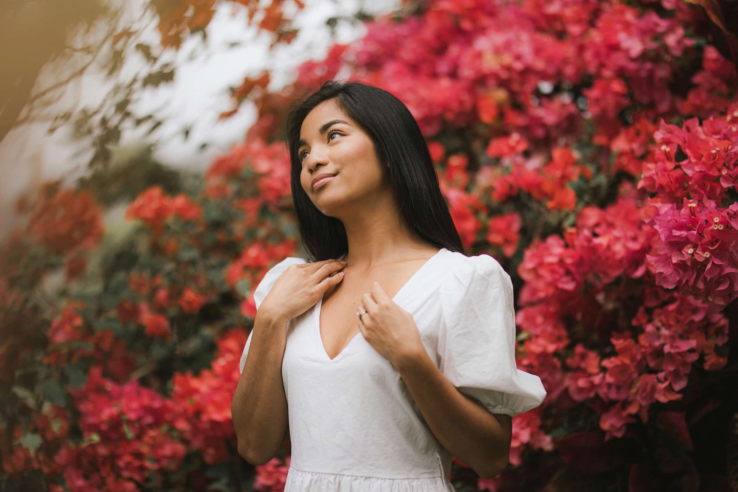 Woman with bougainvillea Woman in a white dress beside pink bougainvillea