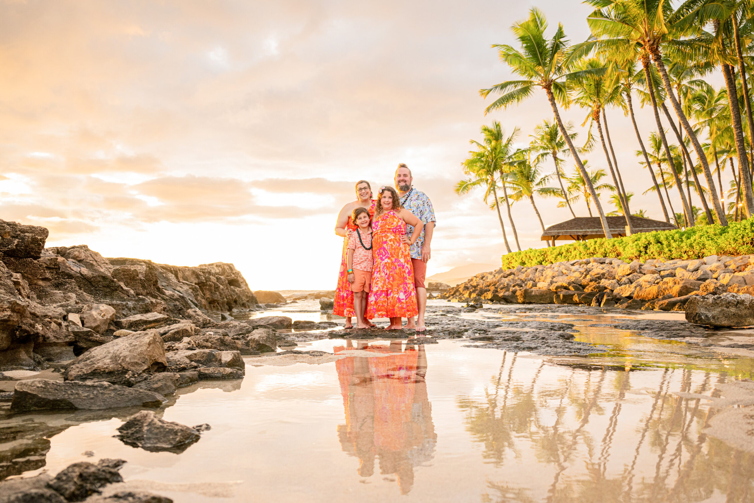 A family enjoying the best time for family beach photos in Hawaii, with golden hour light creating stunning colors.